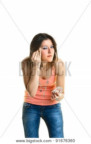 Beautiful young woman putting on make-up