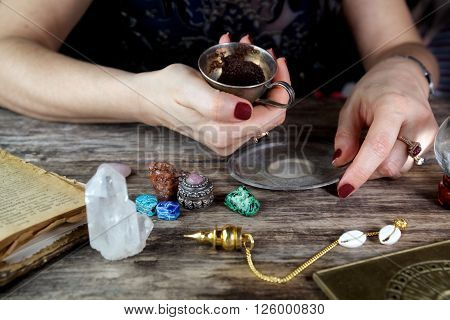 Witch - fortune teller reading fortune from coffee grounds