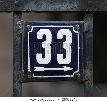 Vintage metal house number on the wall