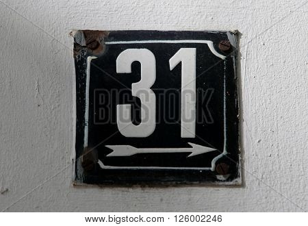 Vintage metal house number on the wall