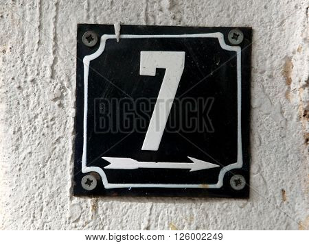 Vintage metal house number on the wall