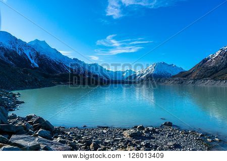 Glacier and lake with turquoise blue water and mountains landscape. Winter mountain landscape with glacier and lake. Tasman glacier Aoraki - Mount Cook National Park New Zealand
