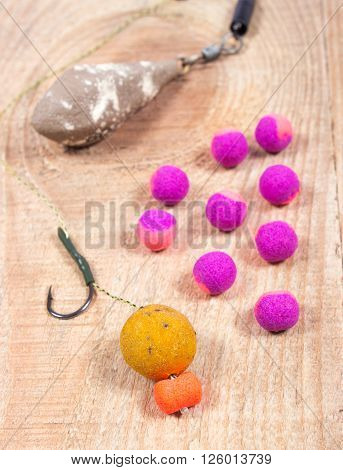 Carp Hook Boilies on wooden background. Close up
** Note: Shallow depth of field