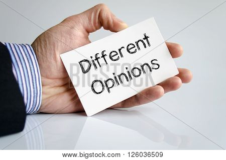 Different opinions note in business man hand