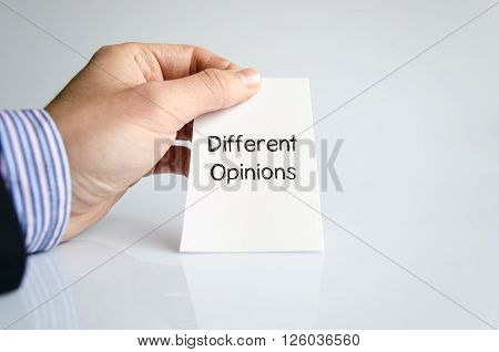 Different opinions note in business man hand