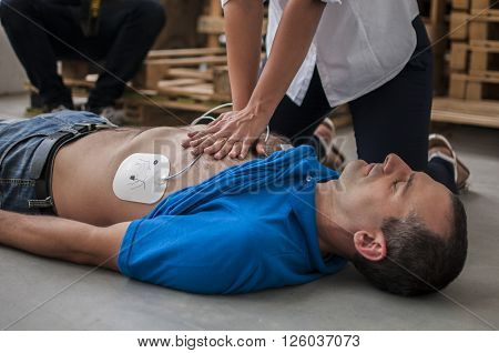 rescuer saving a life making cardiac massage