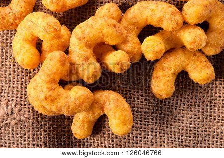 Puffed snacks from above on rustic background