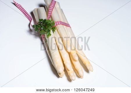 fresh white asparagus with checkered red white rope
