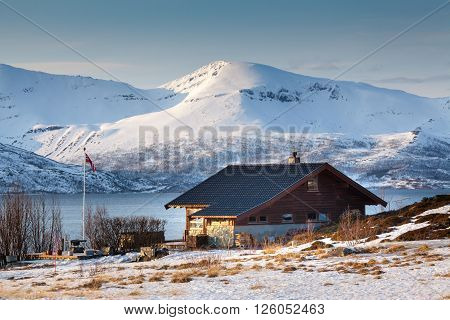 Isolated home and beach on a snowy lake