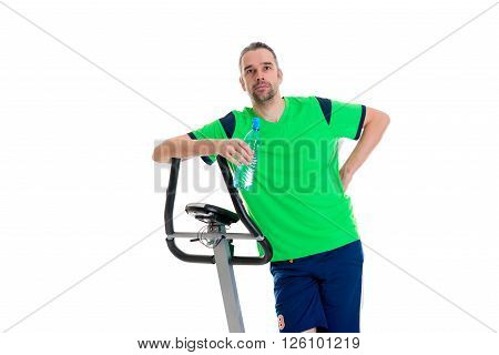 young man in green shirt with water bottle train with fitness machine