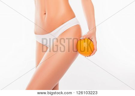 Close Up Portrait Of Sexy Woman Holding Orange Near Her Hip