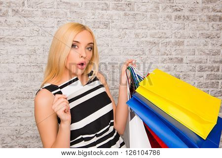 Portrait Of Attractive Shopper Holding Bank Card And Packs With Clothes