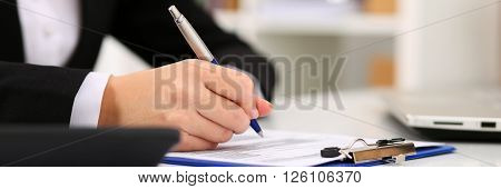 Hand Of Businesswoman Filling And Signing