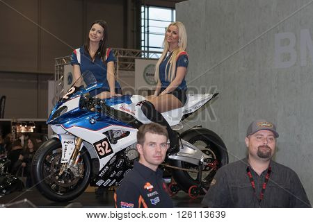 BRNO ,CZECH REPUBLIC-MARCH 4,2016: Beautiful hostesses present motorcycle BMW S 1000 RR on International Fair for Motorcycles on March 4,2016 in Brno in Czech Republic