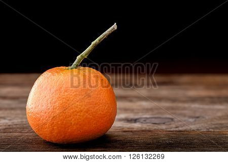 juicy healthy mandarin isolated on wooden table