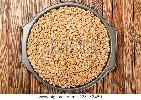 Grilled and roasted peanuts in a big dish.
