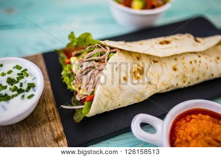 Tortilla with pulled pork, fresh vegetables
