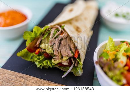 Tortilla with pulled pork, fresh vegetables
