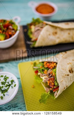 Tortilla with pulled pork, fresh vegetables
