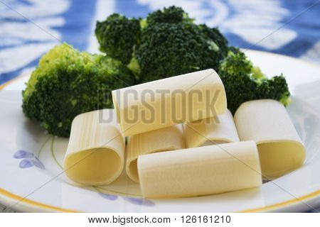 handmade paccheri of gragnano and fresh broccoli on a white dish