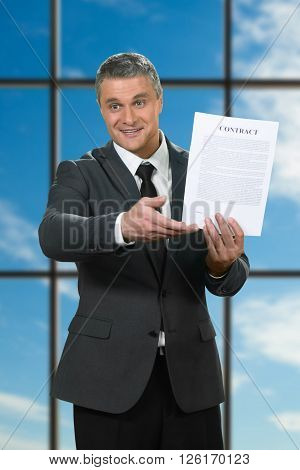 Mature businessman showing contract. Recruiter on blue sky background. Convince and motivate. Read the smallprint.
** Note: Visible grain at 100%, best at smaller sizes