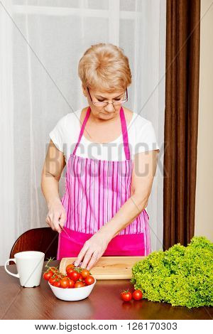 Woman cut red onion on cutting board