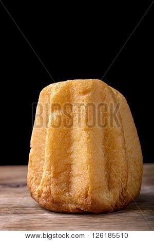 pandoro cake on wood on black background traditional christmas dessert in Italy