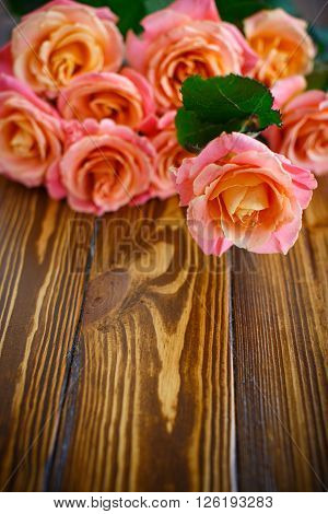 bouquet of pink roses on a wooden table