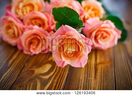 bouquet of pink roses on a wooden table