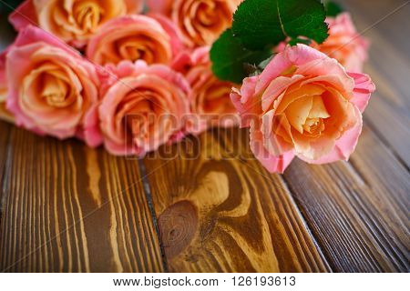bouquet of pink roses on a wooden table