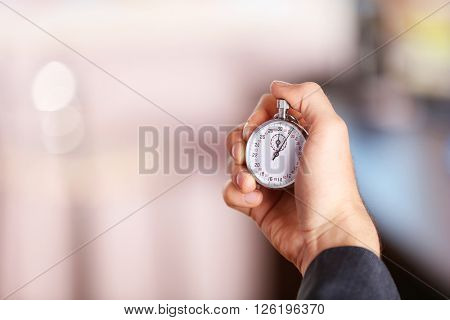 Man holds stopwatch in hand, close up
