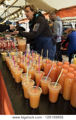 Amsterdam, Holland, April 9, 2016, Selling fresh healthy orange juice at the Noorder market 