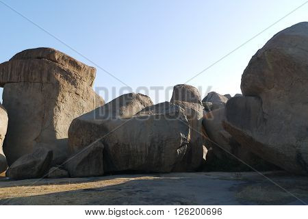 Stone boulders of Hampi in Kartanak's staff in India