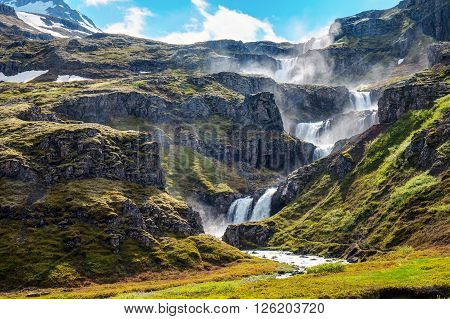 The Klifbrekkufossar waterfall in the Mjoifjordur fjord in Iceland