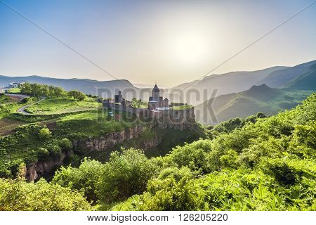 Ancient monastery in setting sun. Tatev. Armenia