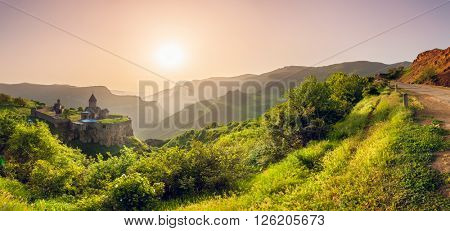 Ancient monastery in setting sun. Tatev. Armenia