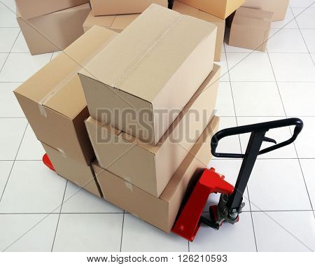 Manual pallet truck with carton boxes indoors