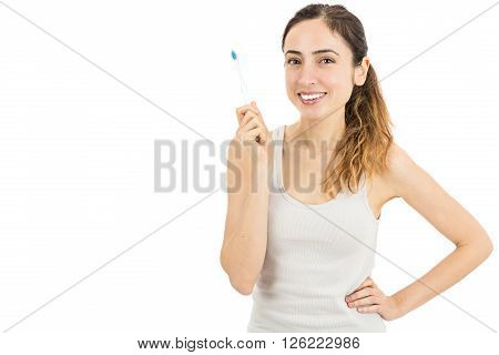 Smiling happy woman with her toothbrush. Isolated on white background.
