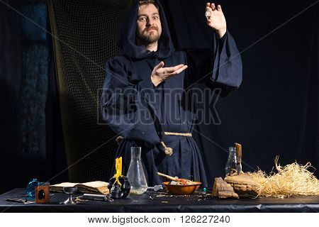 Portrait of a crazy medieval scientist working in his laboratory. Alchemist. Halloween.