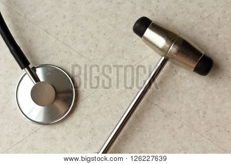 close-up view of stethoscope and neurological hammer