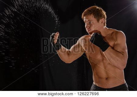 Portrait sportsman boxer in studio against dark background