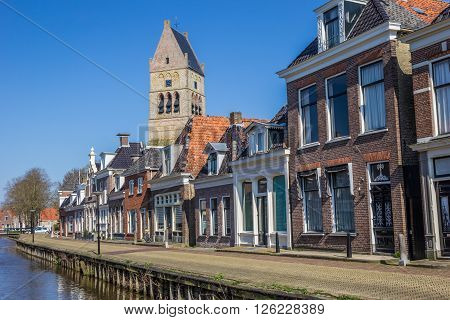 Tower of the martini church along a canal in Bolsward Netherlands