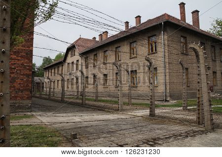 Oswiecim, Poland - May 09, 2015: Electric Fence And Buildings In Former Nazi Concentration Camp Ausc