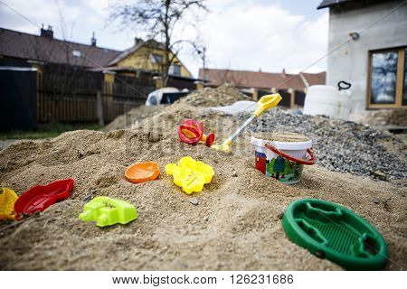 children toys on sand - yeallow red blue green
