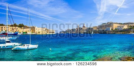 panoramic view of Valetta with sailing boats in turquoise sea. Malta