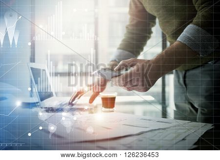 Business concept picture.Businessman working new startup project modern office.Holding contemporary smartphone hands. Worldwide connection technology, stock exchanges graphics interface.