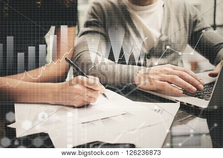 Brainstorming meeting concept.Businessmans crew working investment project modern office.Using contemporary laptop. Worldwide connection technology icons, stock exchanges graphics interface.