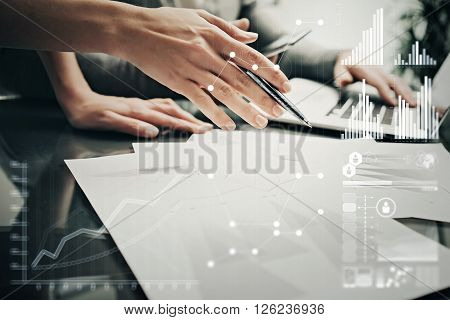 Picture of female hands with pen.Businessmans crew working investment project modern office.Using contemporary laptop. Worldwide connection technology icons, stock exchanges graphics interface.