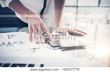 Photo woman reading market reports modern tablet and touching screen with worldwide stock exchange icons. Working process office. Horizontal. Film and blurred