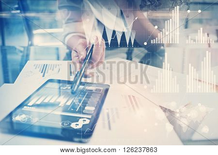 Image of working process. Finance director work new global project in worldwide bank office. Using modern tablet. Graphics icons, tax, stock exchanges interface.